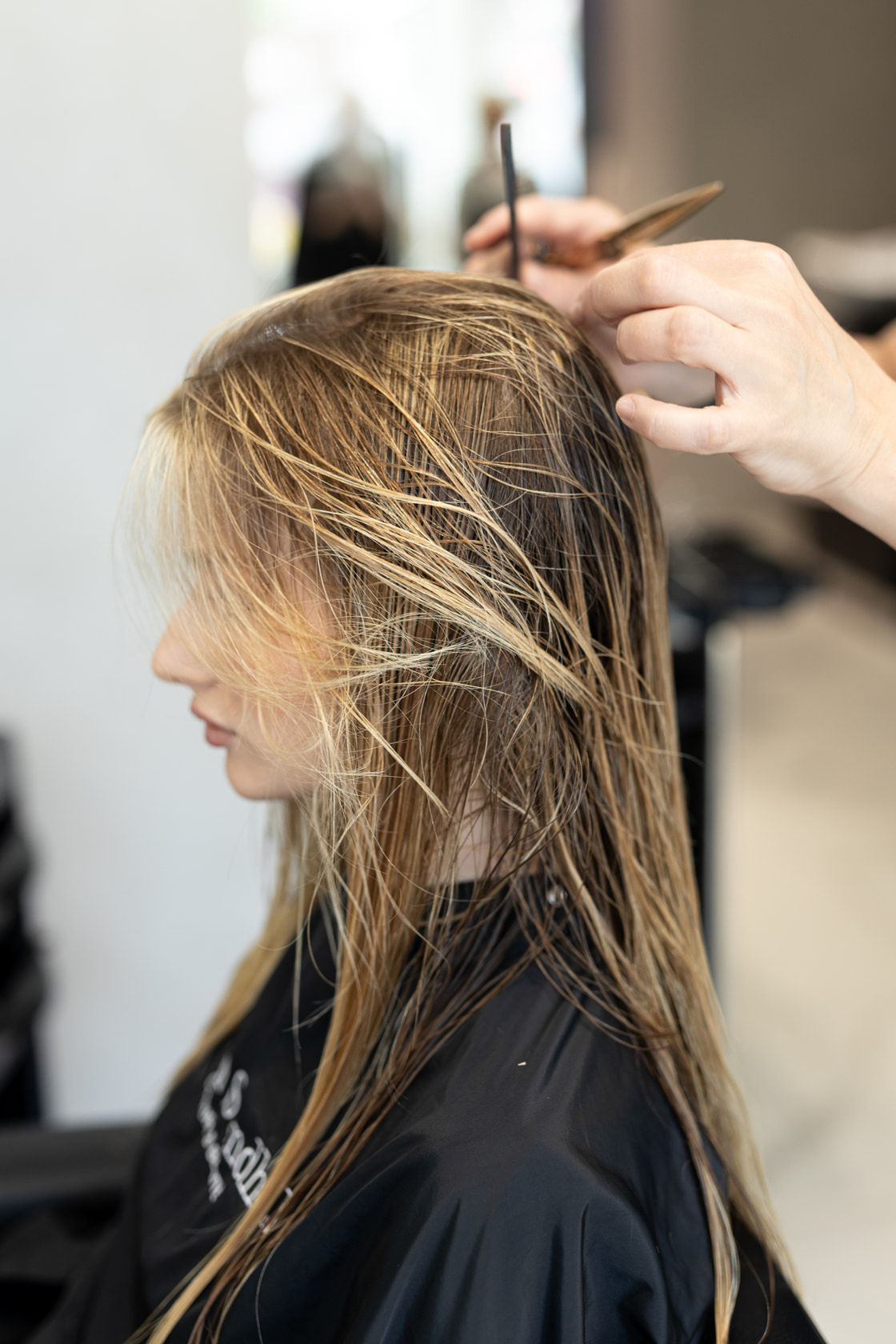 Long damp hair combed through before styling